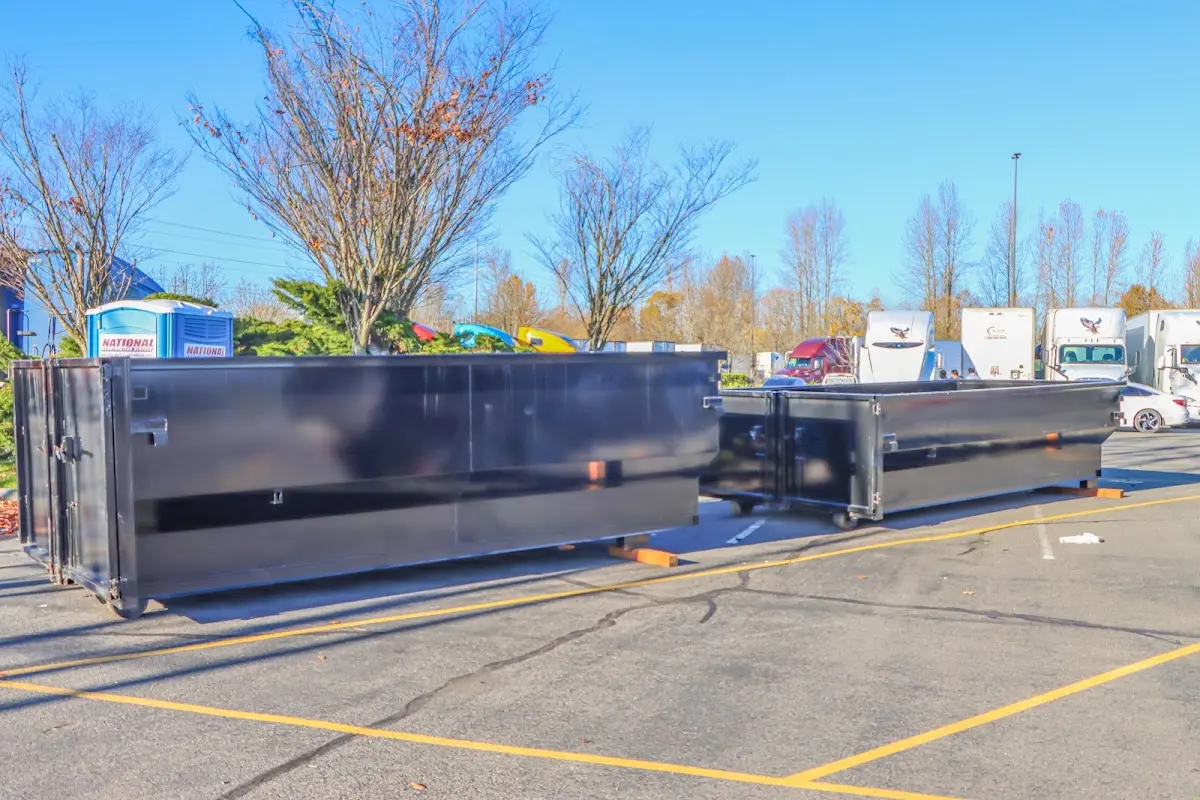 Professional dumpster rental service with roll-off container on residential driveway in University of Virginia